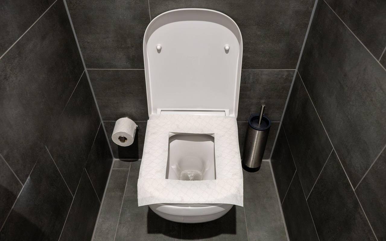 Ein Toilettensitz ist mit Toilettenpapier belegt
